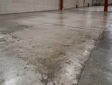 Worn and stained concrete floor in a warehouse