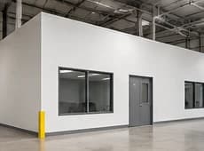 Finished warehouse interior room with drywall walls and windows